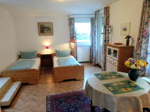 a living room with a couch and a table at Pension Waldheim in Freiburg im Breisgau