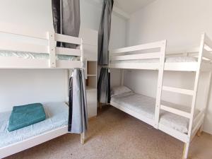 a room with three bunk beds in a dorm room at Daydream Medano Coliving in El Médano