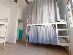 a bedroom with two bunk beds and a window at Daydream Medano Coliving in El Médano