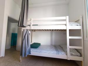 a bedroom with two bunk beds in a room at Daydream Medano Coliving in El Médano