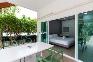 a room with a bed and a table and chairs at Houses of Sunny in Bang Sare +160 photos