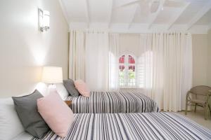 a bedroom with a bed and a couch and a window at Captivating 2-Bed Town-House in Kingston in Kingston