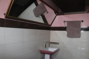 a bathroom with a sink and a mirror at The hotel mountain Taplejung in Tāplejung