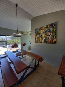 a living room with a table and a painting on the wall at The Miller's Airbnb in Cape Town