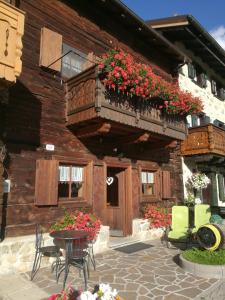 a building with a balcony with flowers on it at Chalet Claudia in Livigno