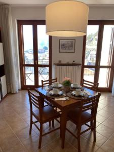 a dining room with a table with chairs and a chandelier at Nonna Felicia B&B in Muro Lucano