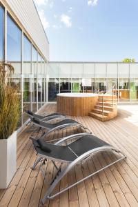 a row of chairs on a deck in front of a building at Estonia Resort Hotel & Spa in Pärnu