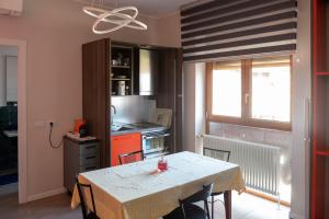 a kitchen with a table and a stove and a window at Milano primaticcio - Monolocale in Milan