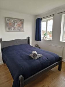 a bed with a towel on it in a bedroom at Home in Melton Mowbray in Melton Mowbray