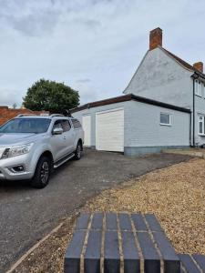 a silver suv parked in front of a house at Home in Melton Mowbray in Melton Mowbray
