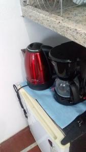 two pots and pans sitting on top of a stove at Antonia Hospedaria 2 in Búzios