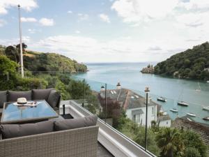 a balcony with a view of the water at Pine Lodge - Private Parking in Kingswear