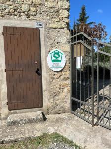 a door to a stone building with a gate at Casa del Viandante Borgo dei Sassi di Roccamalatina in Guiglia