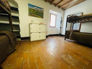 a room with two bunk beds and a dresser and a bedroom at Casa del Viandante Borgo dei Sassi di Roccamalatina in Guiglia