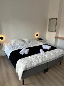 a bedroom with a bed with two slippers on it at D 28 in Bruges