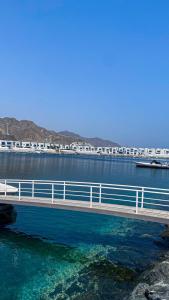 a train crossing a bridge over a body of water at Sunset villa in Fujairah
