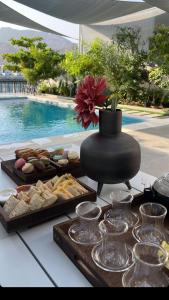 a buffet of food on a table next to a pool at Sunset villa in Fujairah