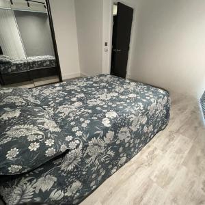 a bedroom with a bed with a blue and white blanket at Luxurious Room Near Train Station in London