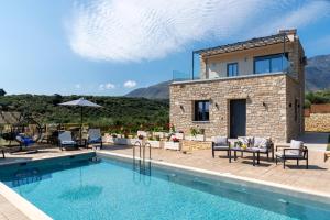 a villa with a swimming pool and a house at Sirena Villa in Chania