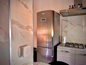 a kitchen with a stainless steel refrigerator and a stove at G&Gapartment in Terni