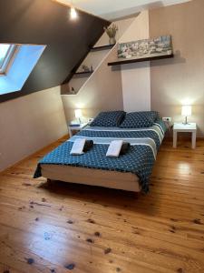 a bedroom with two beds in a attic at La maison des copains in Damery