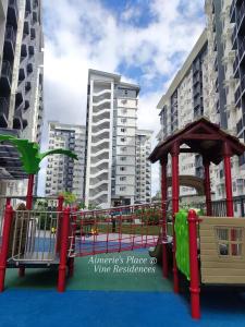 a playground in a city with tall buildings at Vine Residences -Cozy 2BR with Balcony in Manila