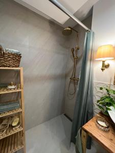 a bathroom with a shower curtain and a table at Privatzimmer mit Balkon in Munich