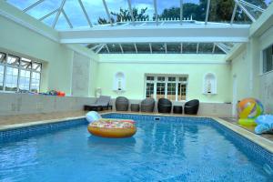 a swimming pool with a donut in the water at Family Retreat or Romantic Break 