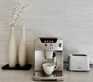 a coffee machine sitting on a counter next to vases at BRÜCKENGLÜCK Alte Mainbrücke - GRATIS KAFFEE - NETFLIX - BALKON in Würzburg