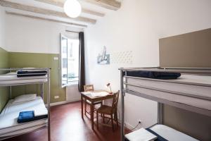 a room with two bunk beds and a table at Hostel Vertigo Vieux-Port in Marseille