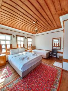 um quarto com uma cama grande e um tapete vermelho em Muhsin Bey Konağı em Saframbolu