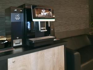a coffee machine sitting on top of a counter at Rheinmetropole Hotel in Düsseldorf +21 photos