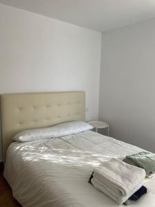 ein Schlafzimmer mit einem weißen Bett mit zwei Handtüchern darauf in der Unterkunft Estupenda casa rural en Hinojos in Hinojos