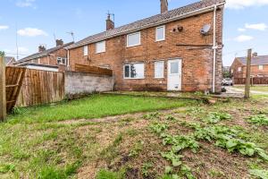 an empty yard in front of a brick house at Stunning Abode in Ashford - Parking - Sleeps 7 in Skegby