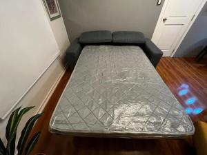 a bed is covered in aluminum foil in a room at APARTAMENTO PROVIDENCIA in Santiago