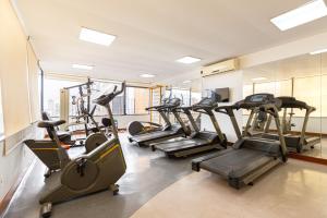 a gym with several treadmills and exercise bikes at SOL - Flats Av Cauaxi By Anora Spaces in Barueri