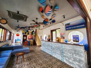 a restaurant with a bar with a blue counter at Fuse Beachside Hoi An in Hoi An