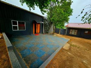 a house with a blue tile driveway in front of it at Adante Lodge & Conferencing in Mthatha