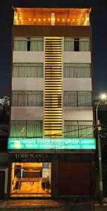 a tall building with a sign in front of it at Torreblanca Hotel in Ilo