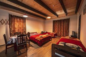 a bedroom with two beds with red comforter at Apartamenty - Grądzkie 19 in Grądzkie