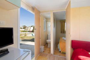 a room with a view of a bathroom with a toilet at Mobile Home 1 - Olhão in Quelfes