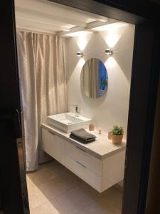 a white bathroom with a sink and a mirror at Hotel Zum Alten Schlagbaum, Garni in Wegberg