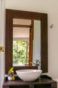 a bathroom with a large mirror and a sink at Finca San José Hotel Boutique in San Antonio del Tequendama