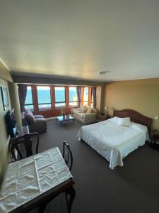 Postel nebo postele na pokoji v ubytování Hotel Apart Colón