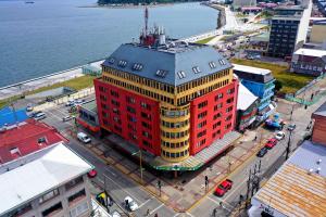 an overhead view of a large red and yellow building at Hotel Apart Colón in Puerto Montt