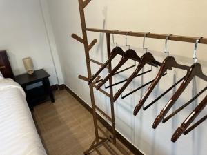 a wooden towel rack in a room with a bed at Good View House - Koh Yao Noi in Ko Yao Noi