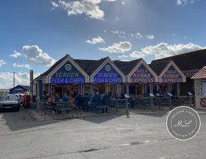 a seafood restaurant with people sitting outside of it at Seaview 190 - Ingoldmells - Close to beach and Fantasy Island in Ingoldmells