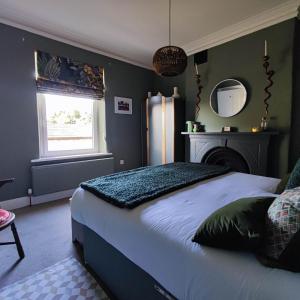 a bedroom with a large bed and a refrigerator at Merchant House in Bootle