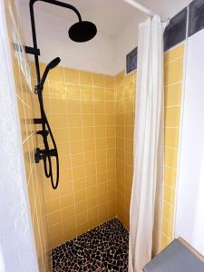 a bathroom with a shower with yellow tiles at Tiny Home Kontík in Luka nad Jihlavou