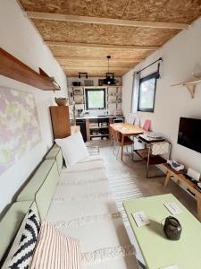 a living room with a couch and a table at Tiny Home Kontík in Luka nad Jihlavou